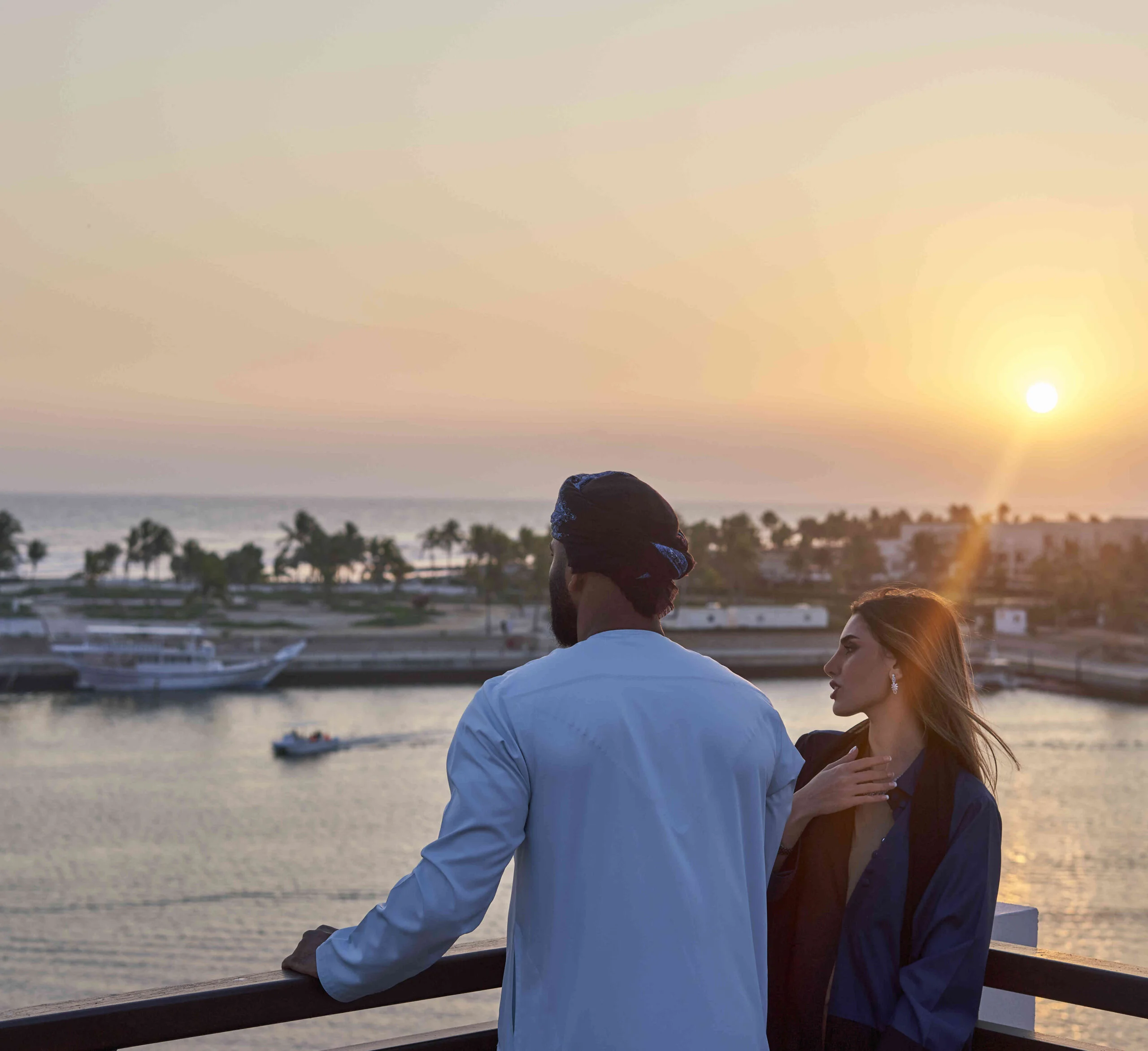 couple watching sunset from juweira boutique hotel room