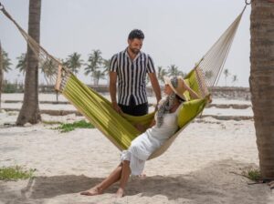 couple on the Hawana Salalah beach enjoying long stay on hamac Oman
