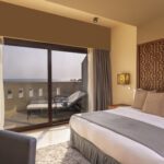king bed and a sunbed in the terrace at fanar resort in hawana salalah oman