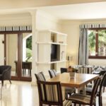 the seating area and the dining table at the three bedroom apartment at fanar resort in hawana salalah oman