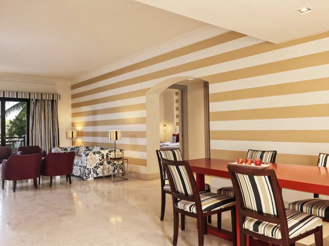 the dining table and seating area at the three bedroom apartment at fanar resort in hawana salalah oman