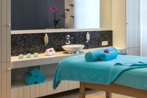 Spa room showing blue towels with Zen Spa logo and massage table at Rotana Salalah Oman