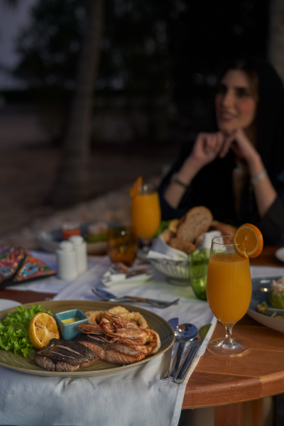 Woman enjoying dinner at Juweira's restaurant 