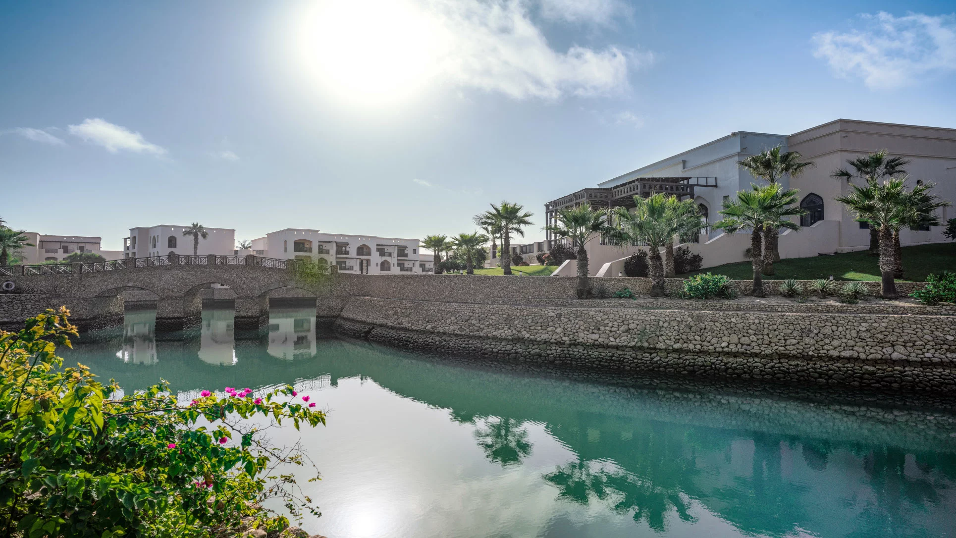 Lagoon at Rotana Salalah With rooms backview and a bridge at Rotana Salalah.