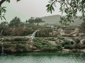 Green nature with small waterfalls during Khareef Season at Wadi Dirbat.