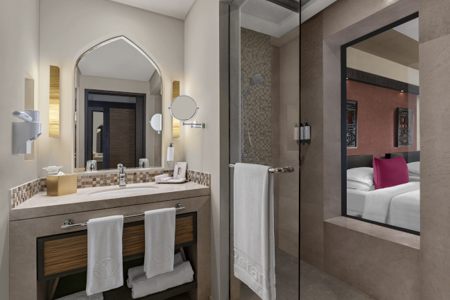 Garden view room bathroom with a marble sink at Rotana Salalah Oman