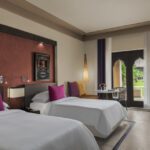 Ocean view room twin bed and balcony at Rotana Salalah Oman