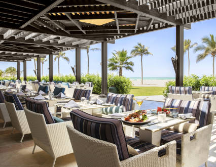 seating area with beach view at beach bar and restaurant in rotana salalah resort