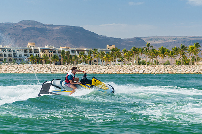 a man enjoy riding a jetski at Hawana Salalah oman.