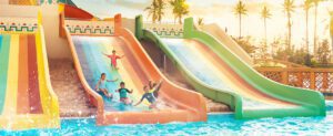 kids sliding into the pool using sliders at Hawana Aquapark