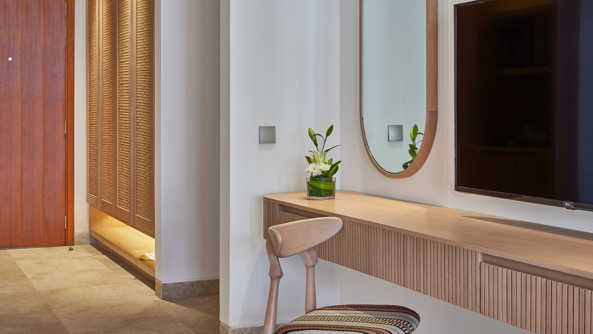 Chair and a mirror inside the rooms of the Club By Fanar Salalah